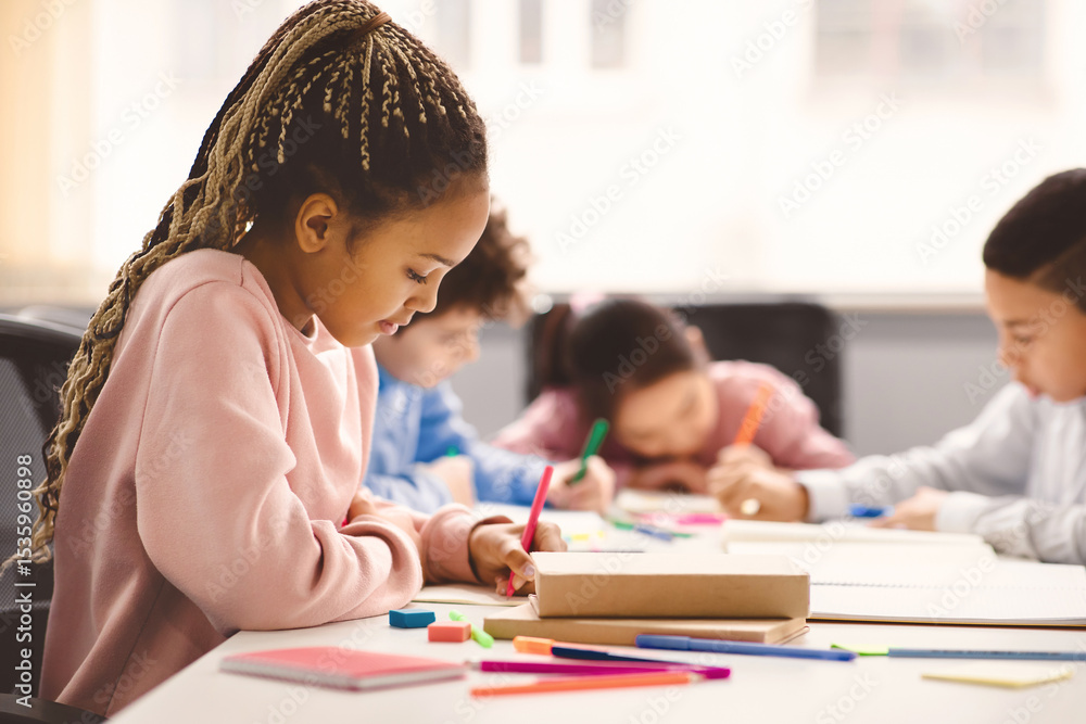 Poster portrait of small black girl with afro braids sitting at table in classroom at primary school or kin