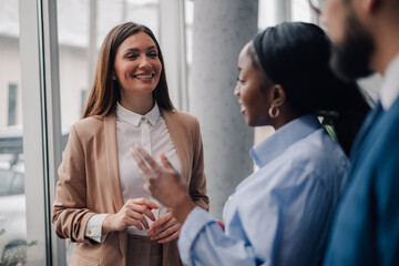 Businesswomen talking and gesturing in modern office