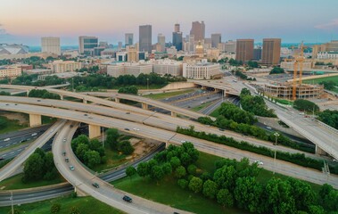 Atlanta, Georgia, USA cityscape and busy highway system at sunset, showing urban life, traffic...