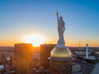 Goddess of Liberty statue atop the Georgia State Capitol dome in Atlanta, USA at sunset. Iconic landmark representing liberty.