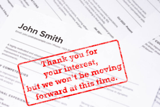 Fake mock CV curriculum vitae for John Smith, marked " Thank you for your interest, but we won&rsquo;t be moving forward at this time". Job search, hiring mismatch, recruitment process, rejection concept.