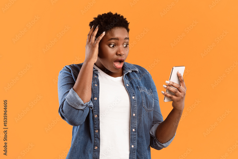 Poster Bad News. Shocked Black Woman Using Phone Touching Head Reading Negative Message Texting Online Standing Over Yellow Studio Background. Mobile Application And Cellphone Problem Concept