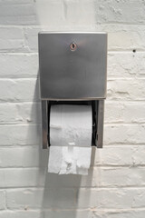 close up on roll of toilet paper on the wall