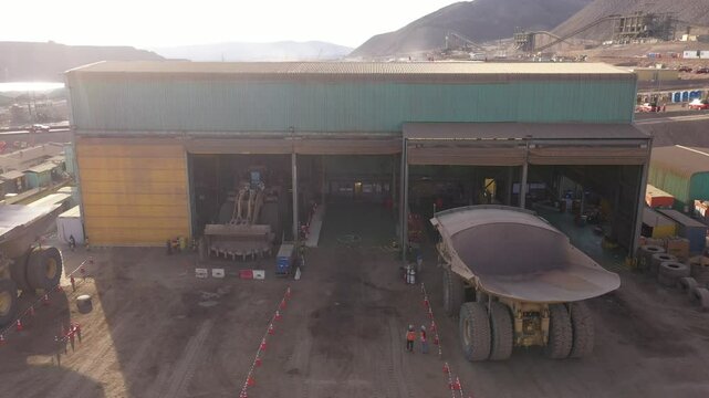 Maintenance of Mining Trucks in Truck Shop &ndash; Mechanics Working on Extraction Vehicles in Northern Chile