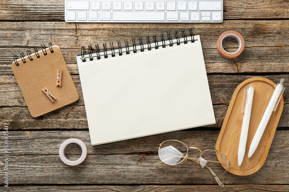 Poster flat lay composition with notebook on wooden table