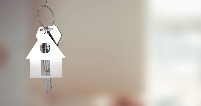 Swinging house-shaped metal keychain with dangling keys on silver key ring in entryway, copy space