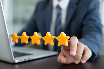 Businessman Holding Five Star Rating on Laptop, Excellent Customer Feedback Concept