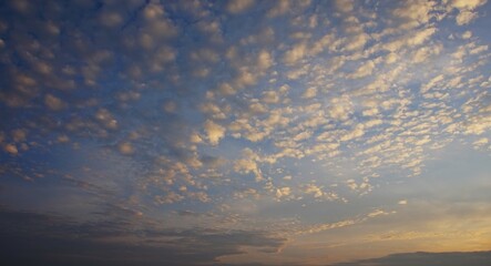 clear sky in the afternoon with yellow clouds highlighted by sunlight