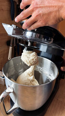 Men's hand opening food processor, after finishing kneading dough for bread or cake. Elegant modern...