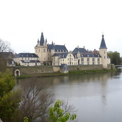 Fototapeta premium Saumur in the Loire, France, as seen from the other side of the Loire River on a grey day
