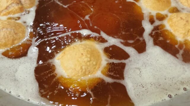 Slow motion frying with brownish black used cooking oil. Cooking oil that is no longer suitable for use. Healthy food concept. 4K footage