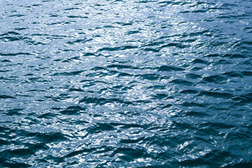 Background of sea water surface. Abstract blue sea water. Background texture. Water in swimming pool, ocean or sea.