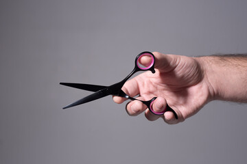 Barber shop. Barber hand holding scissors. Barber professional tools. Background with copy space....