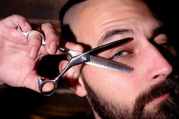 Barber shop. Barber hand holding scissors. Barber professional tools. Male haircut, fashion....