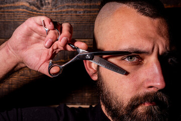 Barbershop. Barber hand holding scissors. Barber professional tools. Male haircut and beard. Barber...