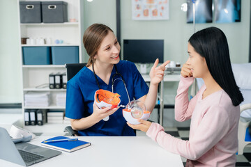  Doctor discussing treatment with Female patient talks to discuss results or symptoms and sitting...
