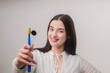 Stomatology. Dental background. Dental hygiene. Dental issues prevention. Dental equipment. Straight white teeth. Girl holding stomatology equipment.