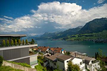Travel background. Hiking and tourism. Switzerland Lake Landscape. Alpine mountains. Lake in the Swiss Alps. Panoramic view. Landscape with green fields along Lake in Switzerland.