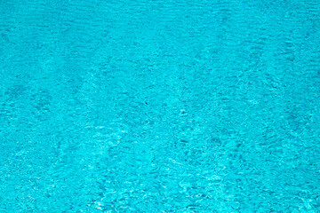 Water view. Transparent water background. Blue pool water texture background. Surface of pool water with ripples.