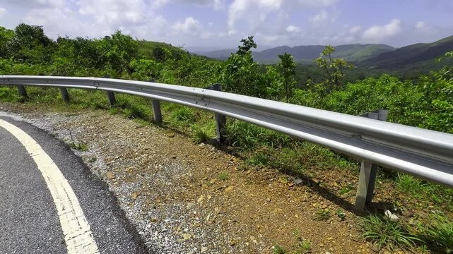 The guard rail, barrier on wayside with cloudy and hill. the straight line from highway fence. image from background, highway fence