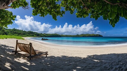 A serene beach scene with a wooden beach chair under the shade of trees on a sunny day