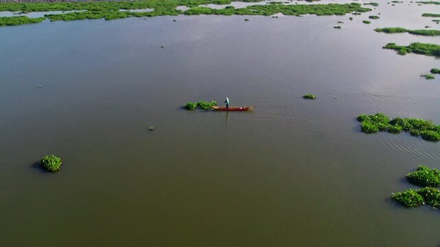 Drone view of fisherman rowing boat in rawa pening lake.