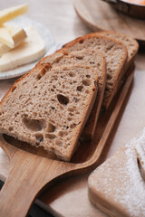 Freshly baked slices of whole grain bread on a wooden board