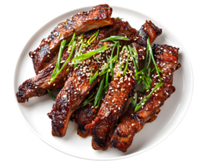 Grilled pork ribs with sesame seeds and scallions served on white plate isolated on transparent background