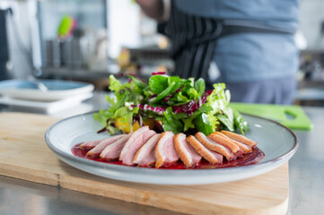 The chef serves roast duck. 