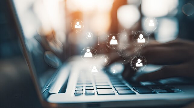 team collaboration icons above laptop with digital overlay - Powered by Adobe