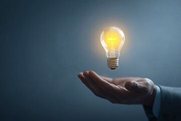 Illuminating idea: A bright lightbulb floats above an open hand, symbolizing inspiration and innovation.