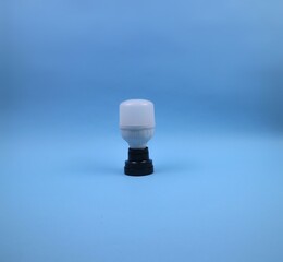 LED Light Bulb and Socket Isolated on Blue Background