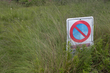 There is a warning sign in the bushes.