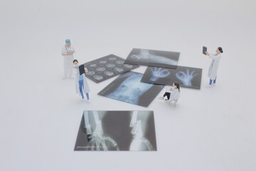 Mini Doctors Analyzing Medical X Rays in Clinical Setting