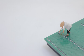 Miniature Figure Gardening on a Circuit Board Depicting Technology