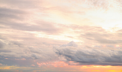 Dramatic overcast sky panorama with gray storm clouds during golden hour sunset creating moody...