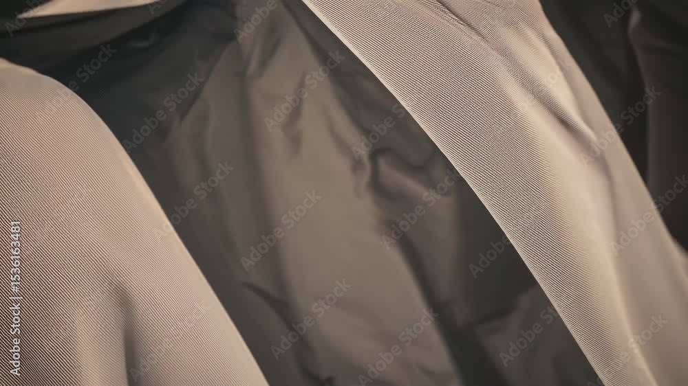 Poster close-up video of flowing fabric with soft lighting, creating a serene and abstract visual. the low-