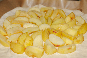 Apples cut into wedges and placed on homemade apple pie crust