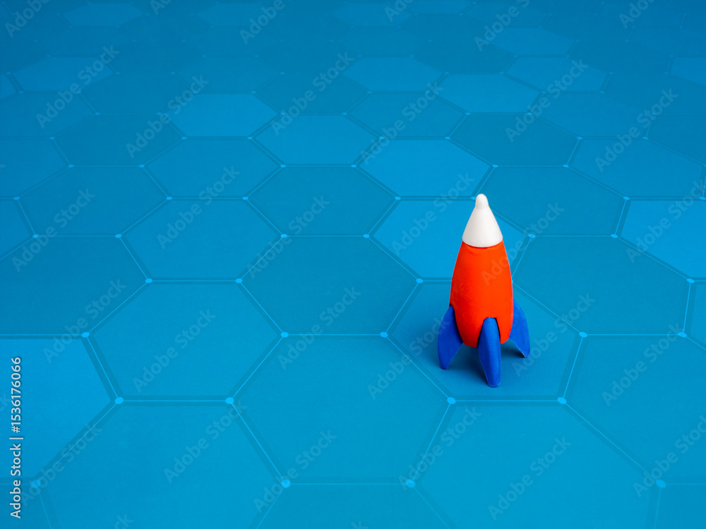 Poster a small toy rocket parking isolated on blue hexagon net pattern background with copy space, minimali