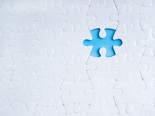 Business solution, solvings and problems, recruitment, creativity concept. Missing piece on blue empty space, gap surrounded with many white blank jigsaw puzzle background, minimalist composition.