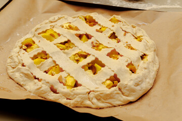 Homemade apple pie, on a baking sheet, ready to go into the oven.
