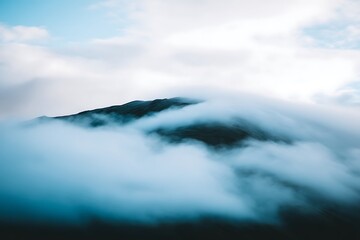 Fototapeta premium Mountain peak veiled by dense cloud
