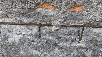 Worn cement wall revealing rustic brick underneath. Authentic high-resolution surface for...