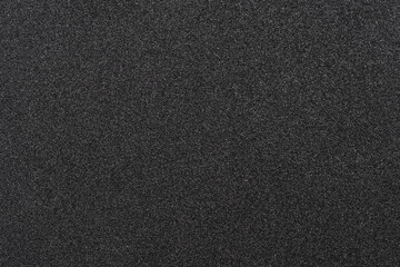 Shiny wrapper paper. black sandpaper texture background. 
