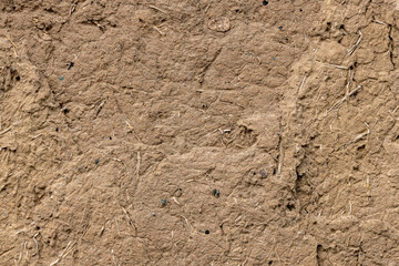 Rustic cob wall texture in outdoor setting during daytime