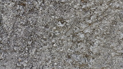 Grunge stone texture of rough concrete wall with vintage style and natural cracks, perfect for industrial background, aged design, rock surface texture, and raw architectural elements.