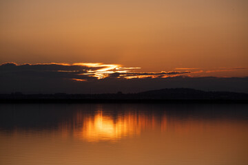Beautiful yellow sunset on the lake.