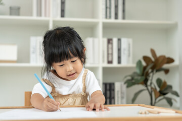 Naklejka premium Happy Asia child play and learn drawing picture and cartoon. Funny family is happy and excited in the house. Mother and daughter having fun spending time together. Holiday, Activity