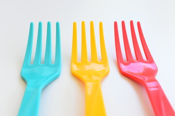 colorful fork isolated on white background, plastic cutlery for picnic