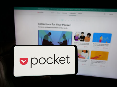 Stuttgart, Germany - 06-06-2025: Person holding smartphone with logo of social bookmarking service Pocket (Mozilla) on screen in front of website. Focus on phone display.